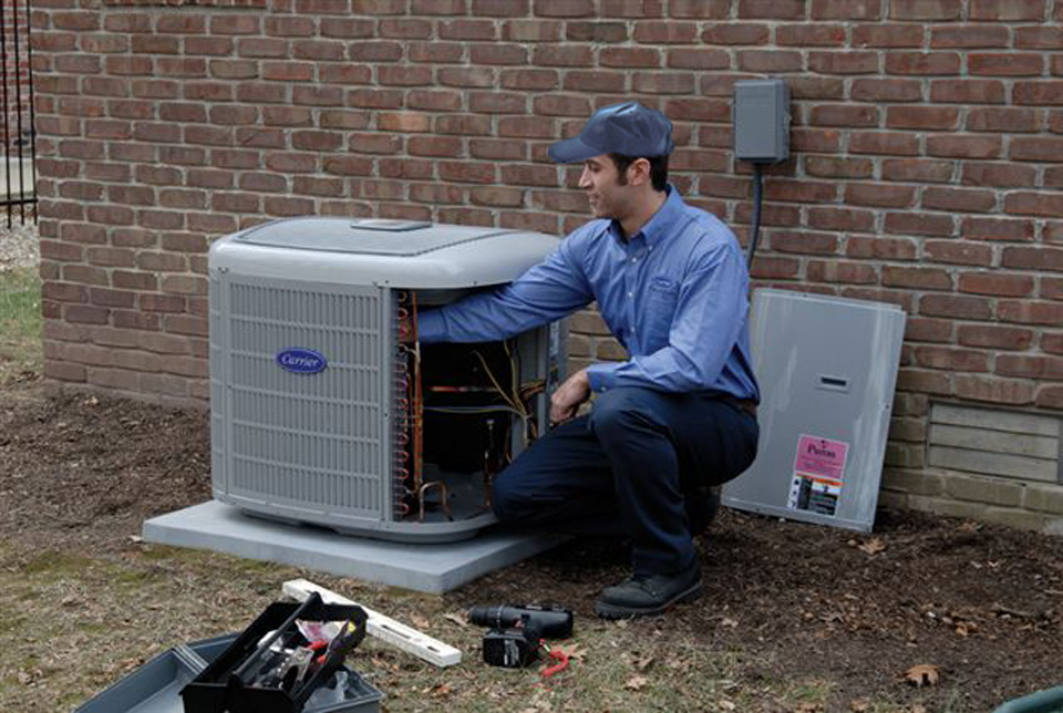 AC Repair tech examines coil